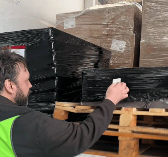 Peel, Stick and Track - label being placed on pallet