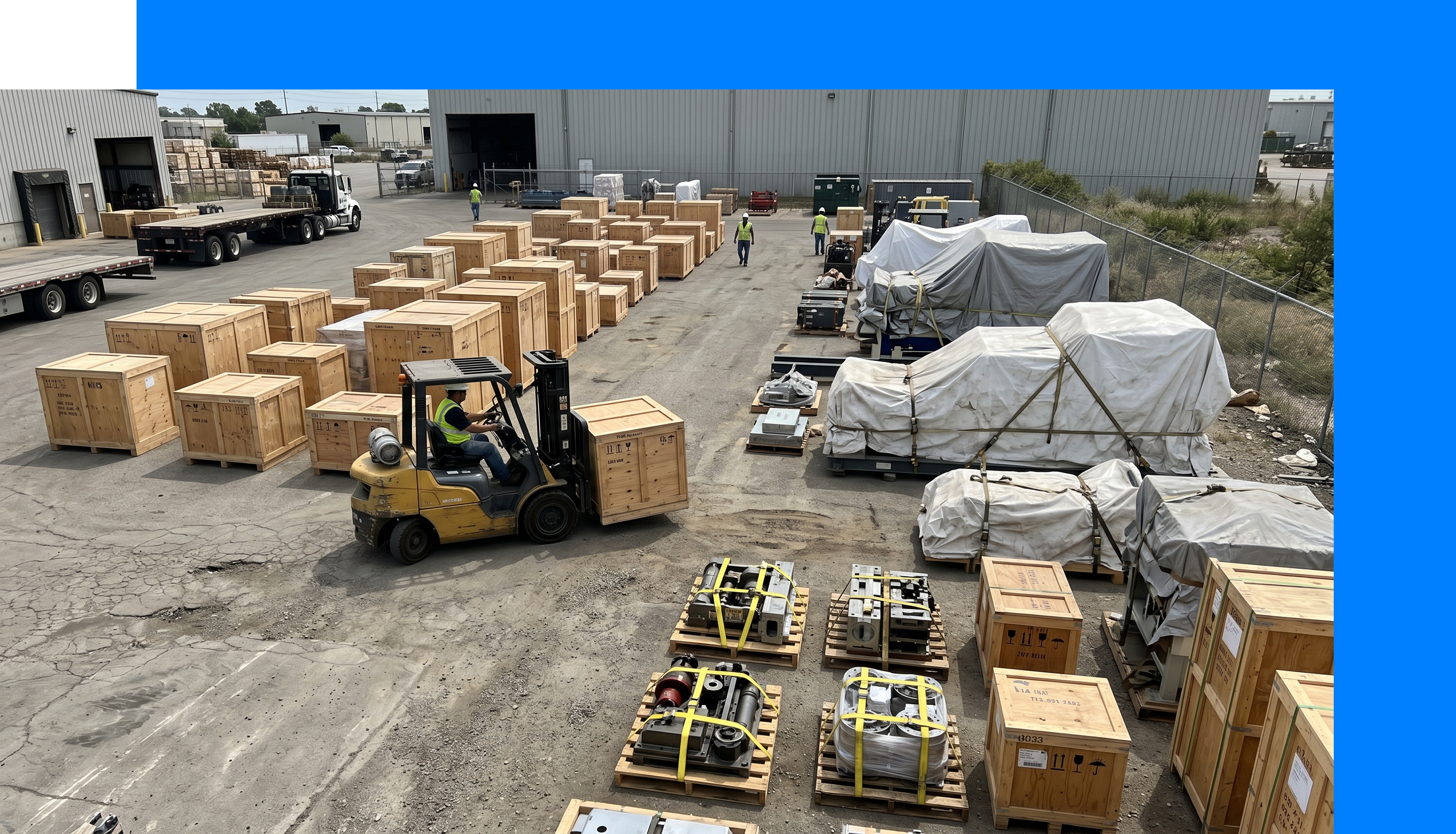 Industrial staging yard with diverse crated and palletised capital equipment ready for inter-site movement.